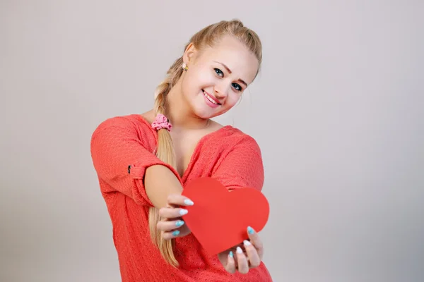 Blonde woman holding a heart — Stock Photo, Image