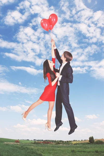 Flying on balloons in the sky, tinted Stock Image