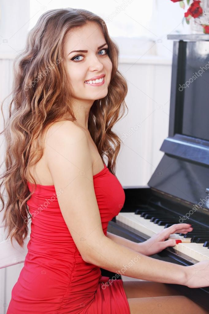 Beautiful woman playing the piano