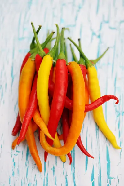 Chili peppers on a wooden board — Stock Photo, Image