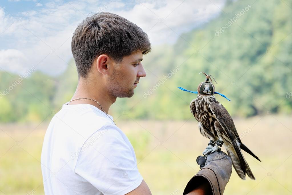 man holding a falcon