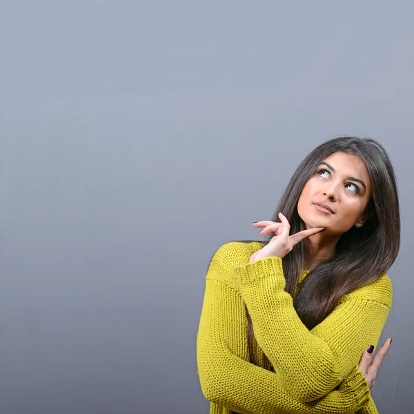 Beautiful woman looking at blank area against  gray background — Stock Photo, Image