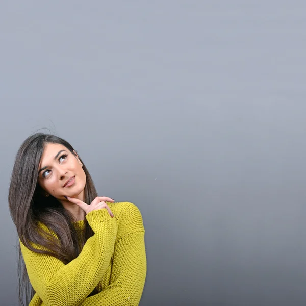Beautiful woman looking at blank area against  gray background — Stock Photo, Image