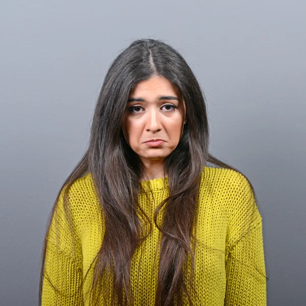 Retrato de una mujer triste sobre fondo gris — Foto de Stock