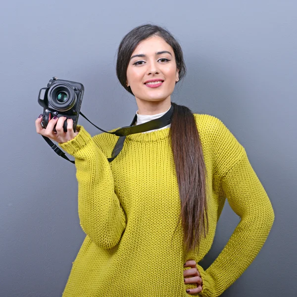 Portrait of beautiful woman photographer holding DLSR camera aga — Stock Photo, Image