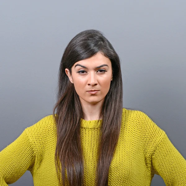 Portrait of mad woman against gray background — Stock Photo, Image