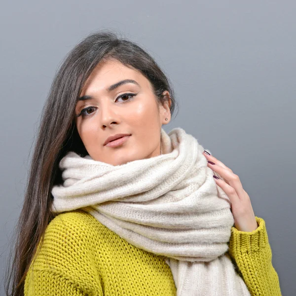 Portrait of young woman in winter clothes against gray backgroun — Stock Photo, Image