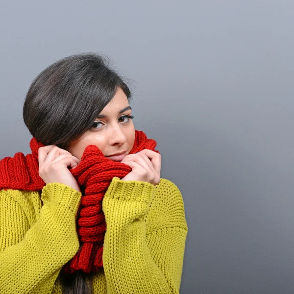 Portrait of young woman in winter clothes against gray backgroun — Stock Photo, Image