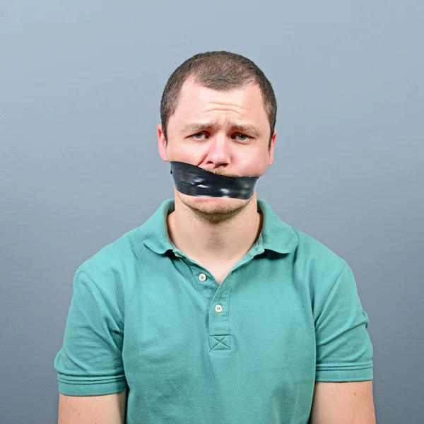 Kidnapped man with tape over his mouth