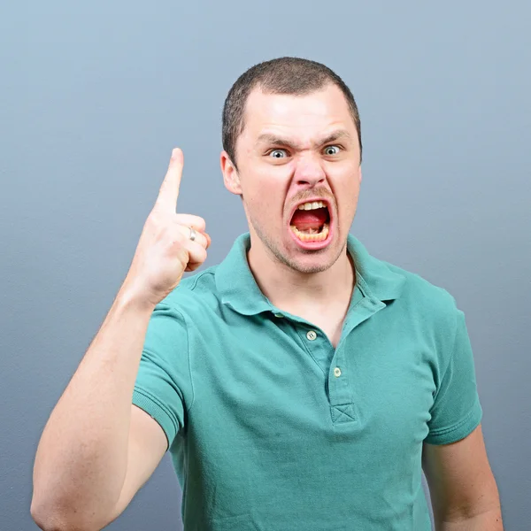 Porträt eines wütenden, drohenden Mannes, der gegen grauen Hintern schreit — Stockfoto