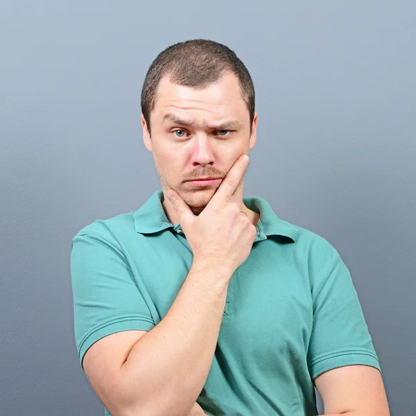 Portrait of a mad looking man against gray background — Stock Photo, Image