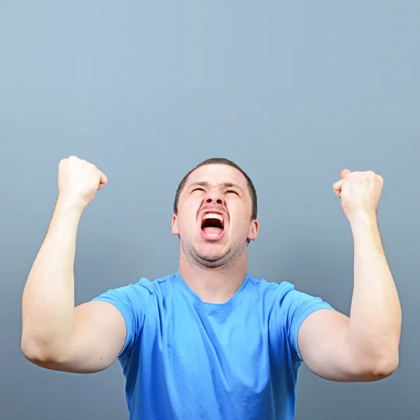 Portrait of ecstatic young man celebrating victory or win agains — Stock Photo, Image