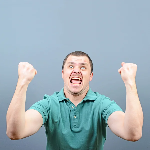 Portrait of ecstatic young man celebrating victory or win agains — Stock Photo, Image