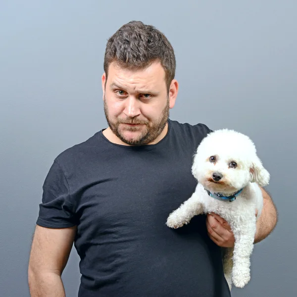 Portrait of funny looking chubby man holding cute small Bichon F — Stock Photo, Image