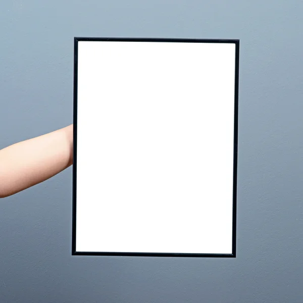 Hand holding blank board against gray background — Stock Photo, Image