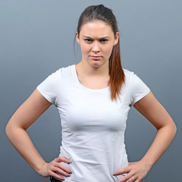 Portrait of mad woman against gray background — Stock Photo, Image