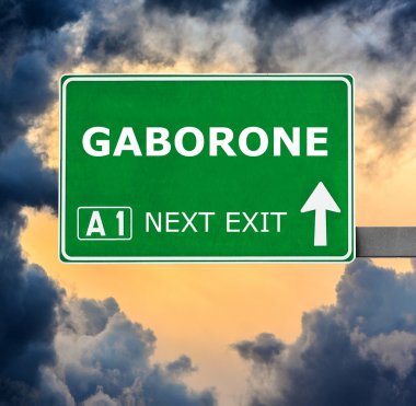 GABORONE road sign against clear blue sky clipart
