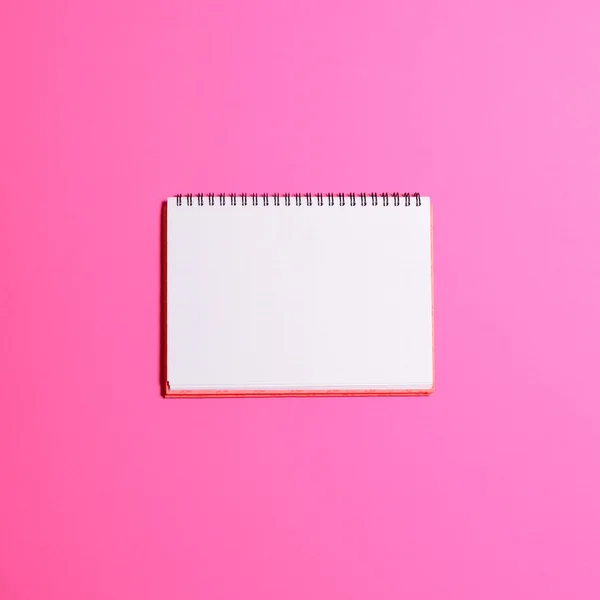 Blank notebook page on pink background  - Flat lay — Stock Photo, Image