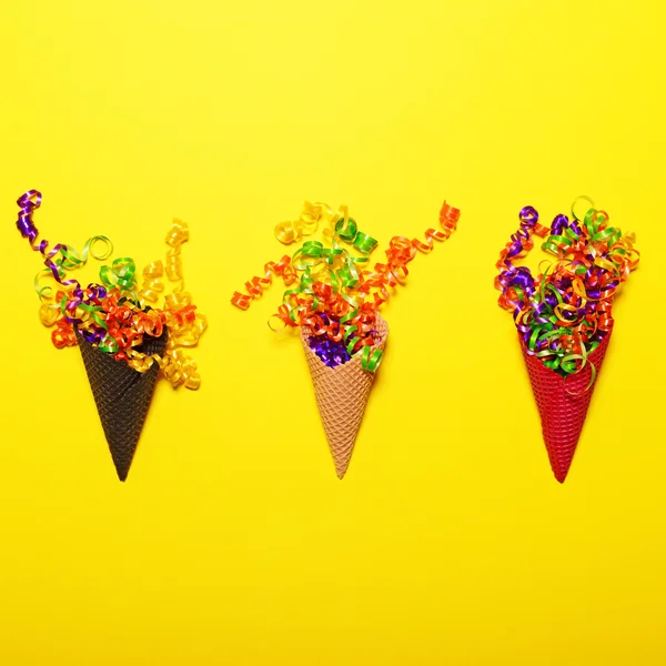 Ice cream cones with colorful confetti on yellow background - Fl — Stock Photo, Image