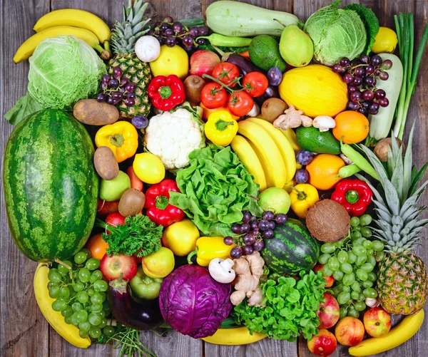 Huge group of fresh vegetables and fruit on wooden background - — Stock Photo, Image