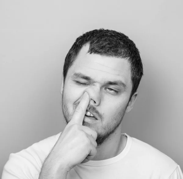 Portrait of a young man with his finger in his nose - Monocrome — Stock Photo, Image