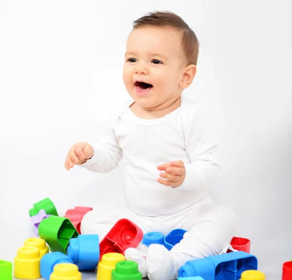 Mooie babymeisje met kleurrijke speelgoed - studio opname — Stockfoto