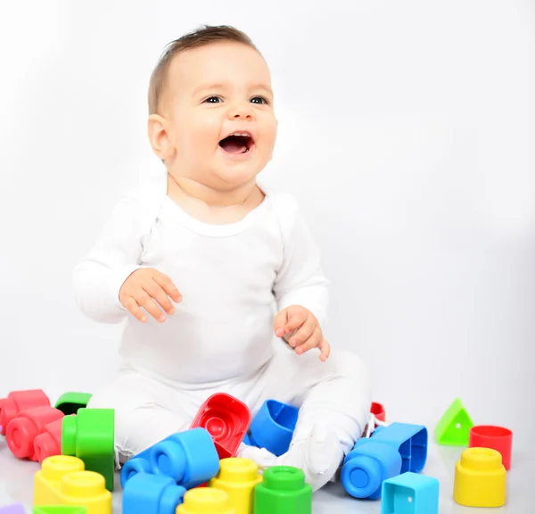 Mooie babymeisje met kleurrijke speelgoed - studio opname — Stockfoto