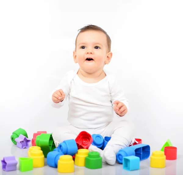 Mooie babymeisje met kleurrijke speelgoed - studio opname — Stockfoto