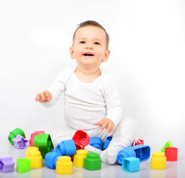 Mooie babymeisje met kleurrijke speelgoed - studio opname — Stockfoto