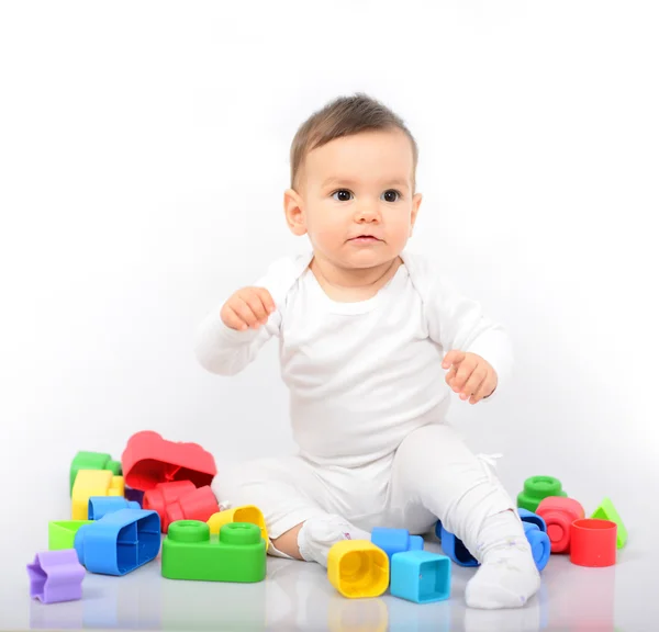 Mooie babymeisje met kleurrijke speelgoed - studio opname — Stockfoto