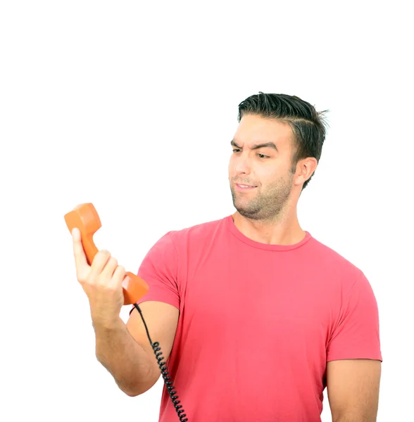 Portrait of young man in shock while talking on phone having unp — Stock Photo, Image