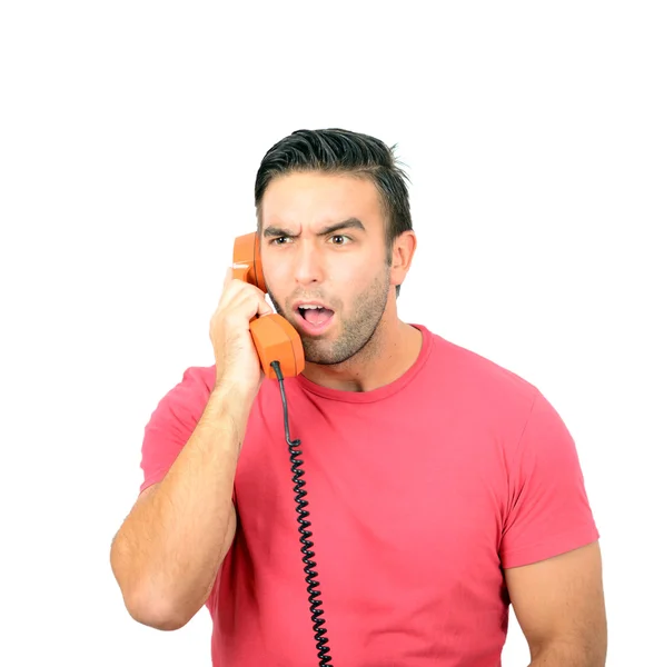 Portrait of young man in shock while talking on phone having unp — Stock Photo, Image