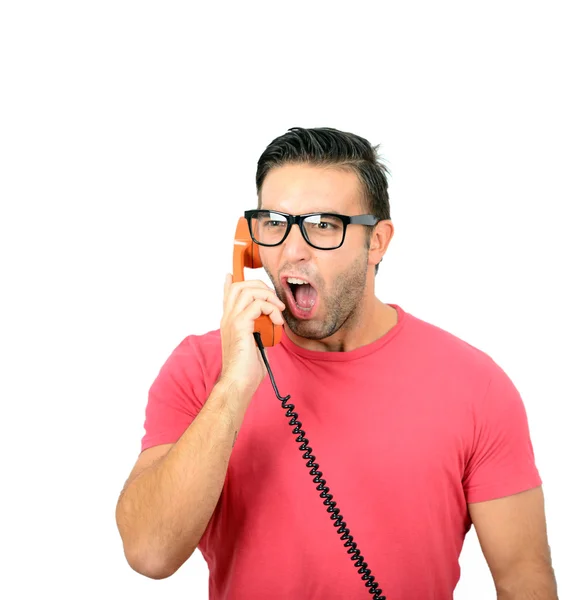 Porträt eines jungen Mannes, der vor weißem Hintergrund am Telefon brüllt — Stockfoto