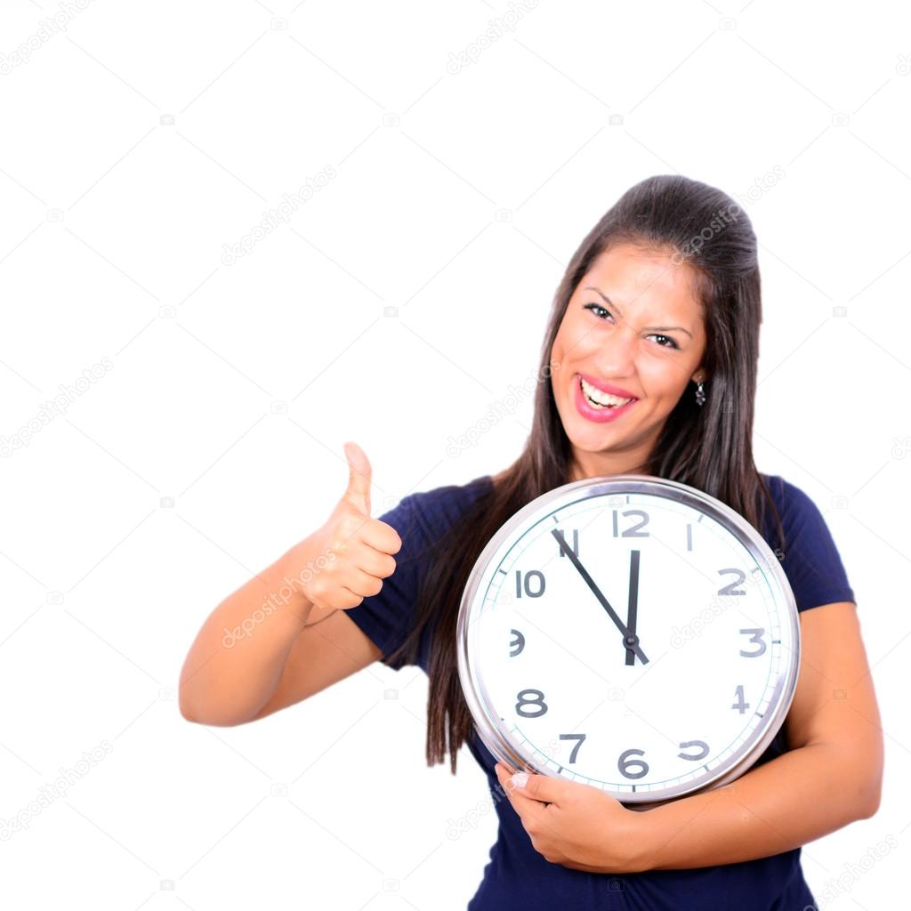 Portrait of beautiful young woman holding big clock with thumbs 