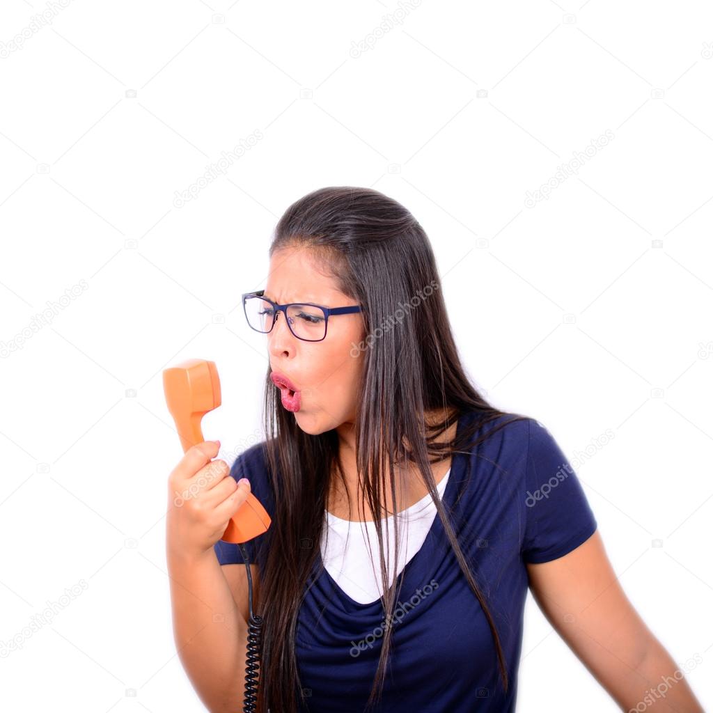 Portrait of young female yelling at phone against white backgrou