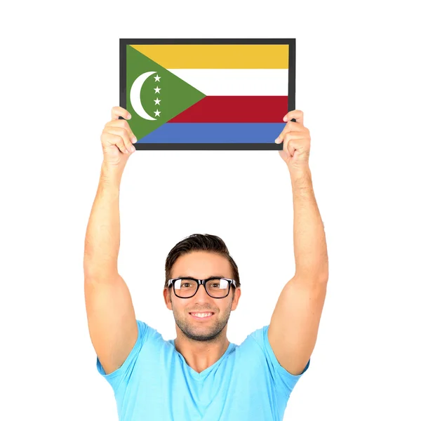 Portrait of a young casual man holding up board with National fl — Stock Photo, Image