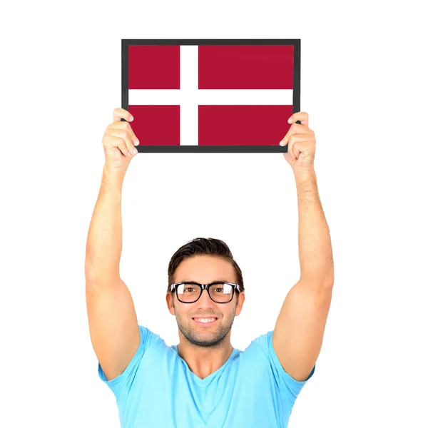 Portrait of a young casual man holding up board with National fl — Stock Photo, Image