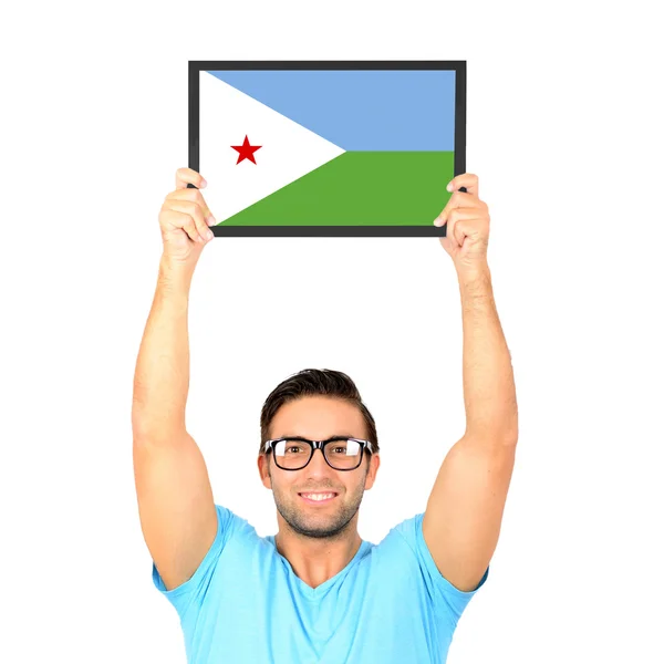 Portrait of a young casual man holding up board with National fl — Stock Photo, Image