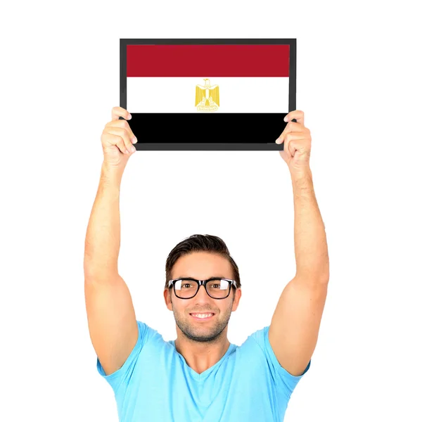 Portrait of a young casual man holding up board with National fl — Stock Photo, Image