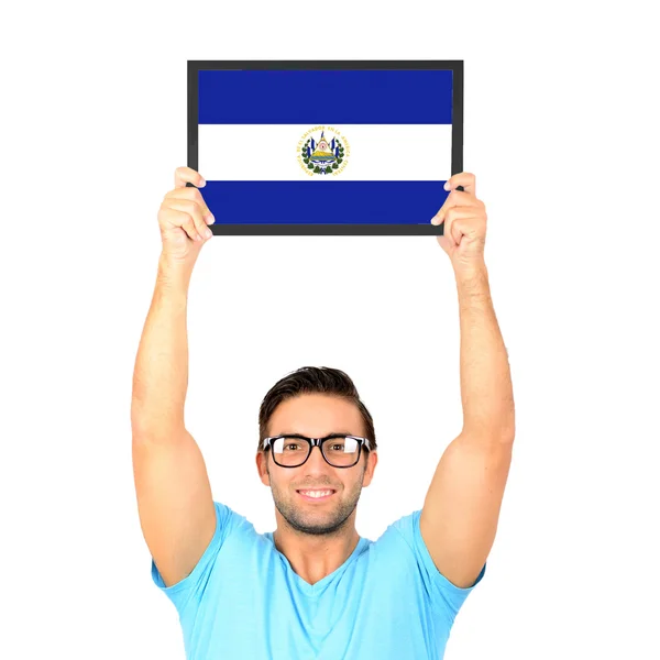 Portrait of a young casual man holding up board with National fl — Stock Photo, Image