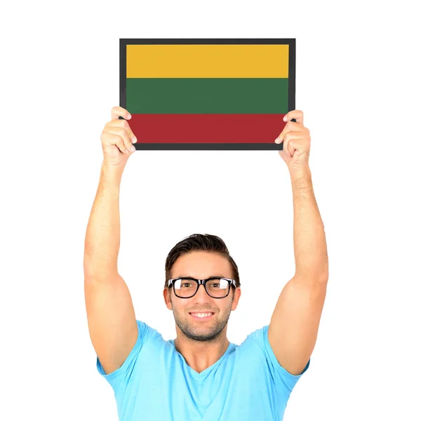 Retrato de un joven casual sosteniendo la tabla con National fl — Foto de Stock