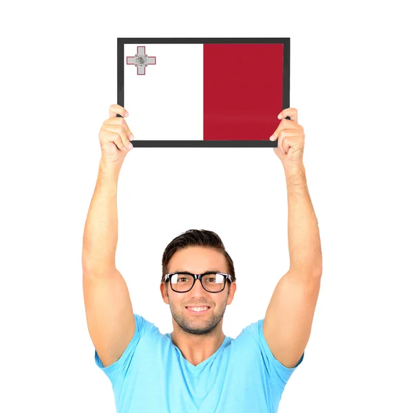 Portrait of a young casual man holding up board with National fl — Stock Photo, Image