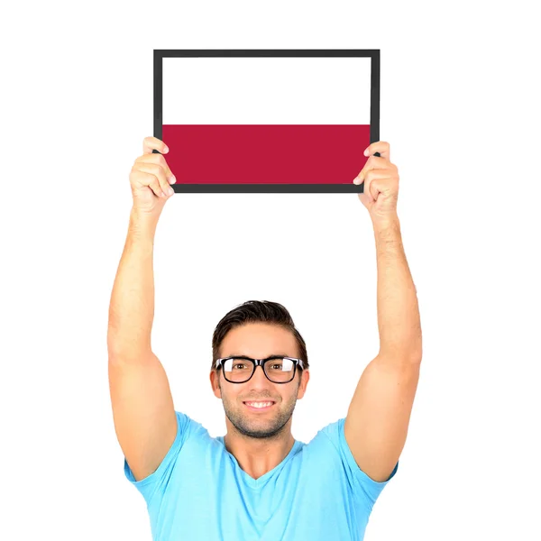 Portrait of a young casual man holding up board with National fl — Stock Photo, Image