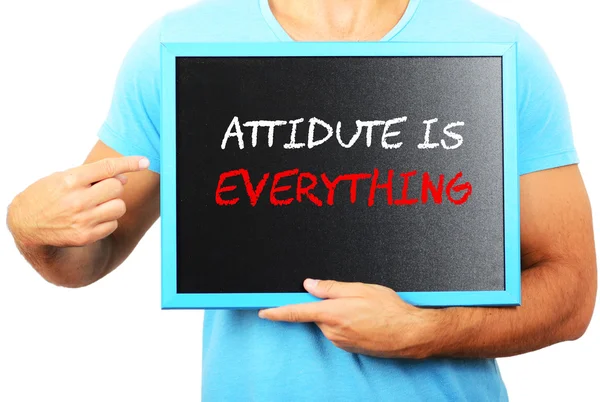 Man holding blackboard in hands and pointing the word ATTITUDE I — Stock Photo, Image