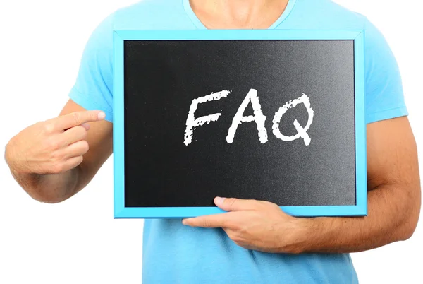 Man holding blackboard in hands and pointing the word FAQ — Stock Photo, Image
