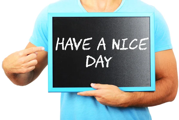 Man holding blackboard in hands and pointing the word HAVE A NIC — Stock Photo, Image