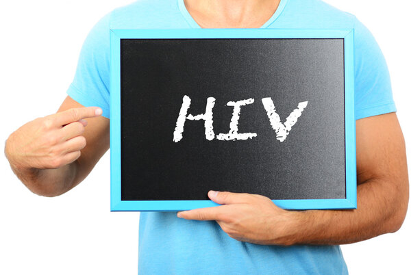 Man holding blackboard in hands and pointing the word HIV