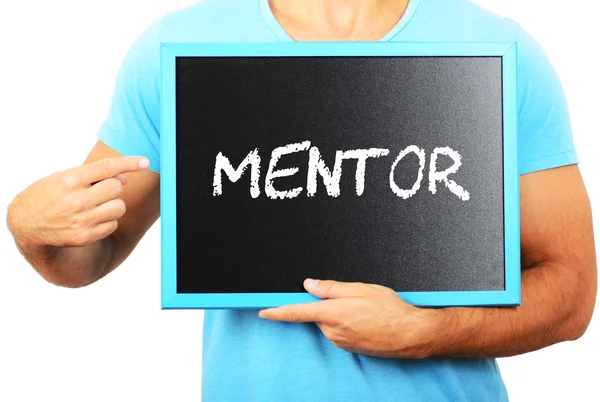 Man holding blackboard in hands and pointing the word MENTOR — Stock Photo, Image