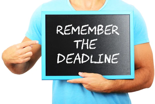 Man holding blackboard in hands and pointing the word REMEMBER T — Stock Photo, Image