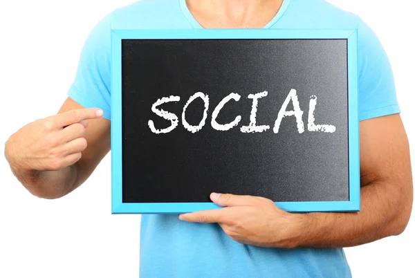 Man holding blackboard in hands and pointing the word SOCIAL — Stock Photo, Image